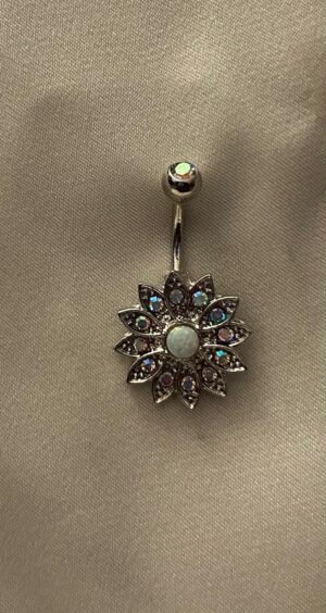 Silver daisy-shaped earrings with opal center and intricate crystal-studded petals, hanging elegantly from a Silver stud.