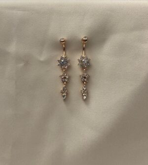 Rose Radiant Star earrings with intricate crystal snowflake-inspired designs, elegantly dangling from a polished Golden stud.